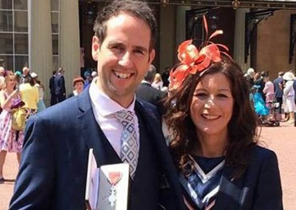 David and wife Katie at Buckingham Palace with his MBE EMN-160615-145303001