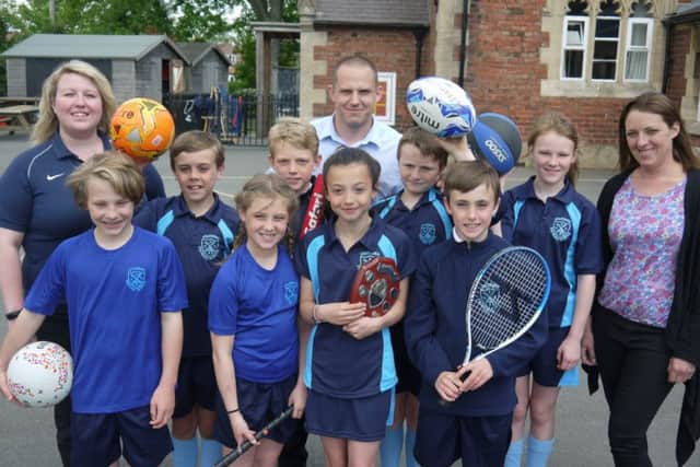 Pupils show off their new kit with, from left, PE co-ordinator Sarah Minnaar, headteacher Matt Lee and Mary Swain, representing the Friends of the School and Stathern Duathlon
PHOTO: Supplied