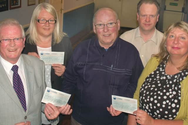 Douglas Wilson (Voluntary Sction Melton's gardening scheme), Rhonda Fazakerley (Age UK) and Sue Mulligan (Melton Mencap) receive their cheques from Charity Cup chairman Graham Digby and secretary Alan Digby EMN-160621-144512002