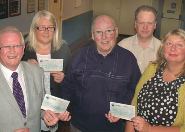 Douglas Wilson (Voluntary Sction Melton's gardening scheme), Rhonda Fazakerley (Age UK) and Sue Mulligan (Melton Mencap) receive their cheques from Charity Cup chairman Graham Digby and secretary Alan Digby EMN-160621-144512002