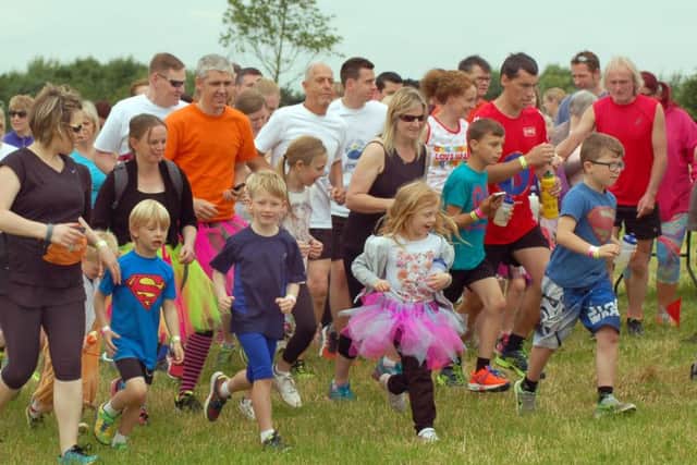 Children lead the way at the fun run start. EMN-160622-103347002