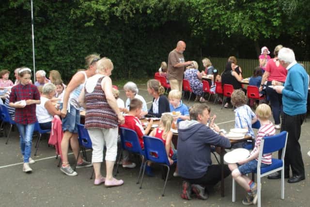 Children and their grandparents enjoy a tea party for the Queen's 90th birthday
PHOTO: Supplied
