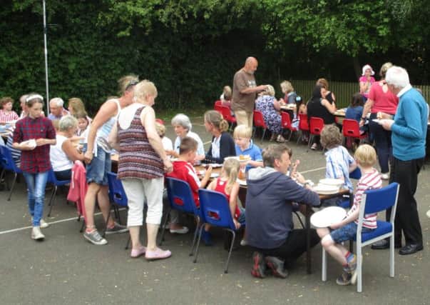 Children and their grandparents enjoy a tea party for the Queen's 90th birthday 
PHOTO: Supplied