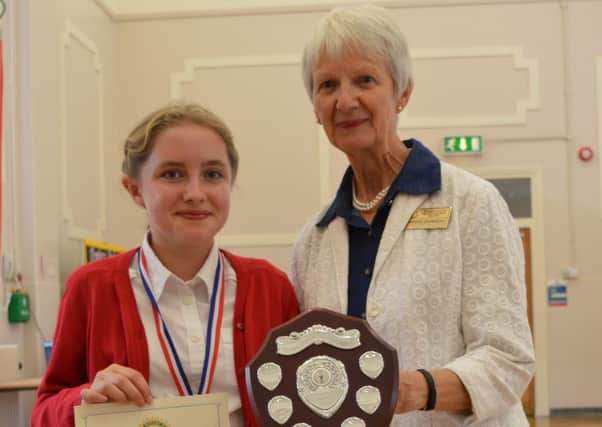 Brownlow Primary School pupil Izabella Roberts (10) receives her award from Maggie Saunders, from the Rotary Club of Melton Belvoir EMN-160624-190817001