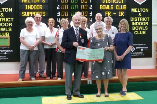 David Fry hands over the cheque to Elizabeth Mills and Caroline Hammond (right) from FR-IR. Also pictured, from left, back - Iris and Malcolm Nutter, Pat Hesketh, Val Noone, Peter Bailey, Thelma Stubbs, Mick Rawle, Eva Radford EMN-160628-152920002