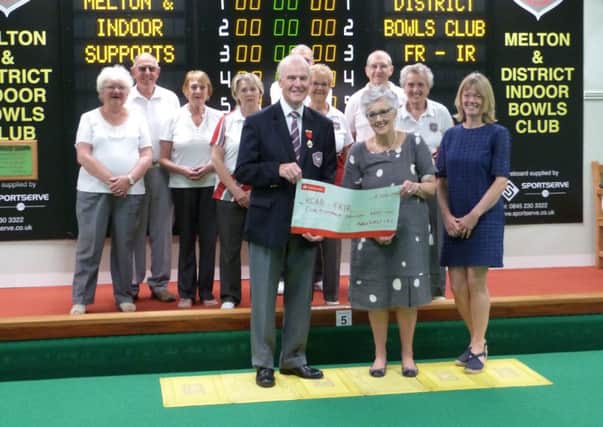 David Fry hands over the cheque to Elizabeth Mills and Caroline Hammond (right) from FR-IR. Also pictured, from left, back - Iris and Malcolm Nutter, Pat Hesketh, Val Noone, Peter Bailey, Thelma Stubbs, Mick Rawle, Eva Radford EMN-160628-152920002