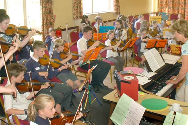 Music teacher Zosia Cocker conducts the children during their Violins in the Vale production PHOTO: Tim Williams