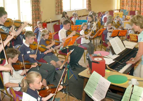 Music teacher Zosia Cocker conducts the children during their Violins in the Vale production PHOTO: Tim Williams