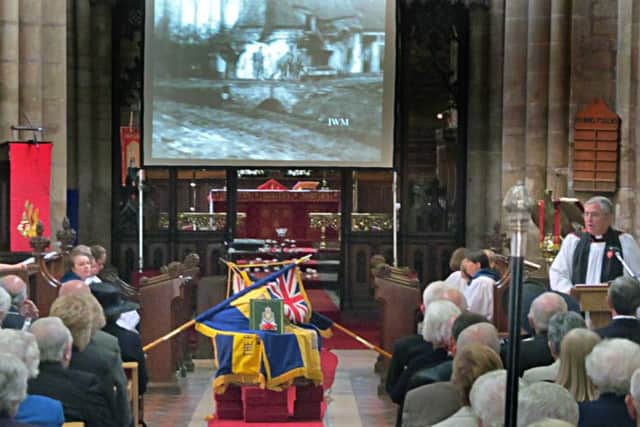 The Reverend Kevin Ashby leads the service with footage from The Somme as a backdrop EMN-160407-110813001