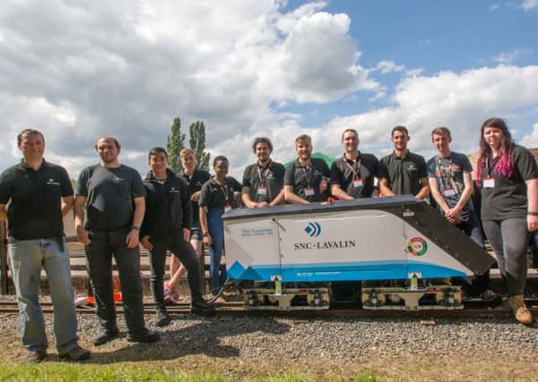 The winners SNC-Lavalin's Rail and Transit team pictured alongside their innovative locomotive engine 
PHOTO: David Shirres