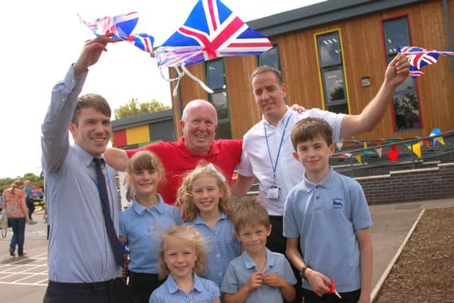 Executive headteacher Gareth Nelmes (right), with staff and pupils, celebrate the opening of the new school extension PHOTO: Tim Williams