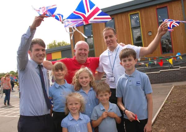 Executive headteacher Gareth Nelmes (right), with staff and pupils, celebrate the opening of the new school extension PHOTO: Tim Williams