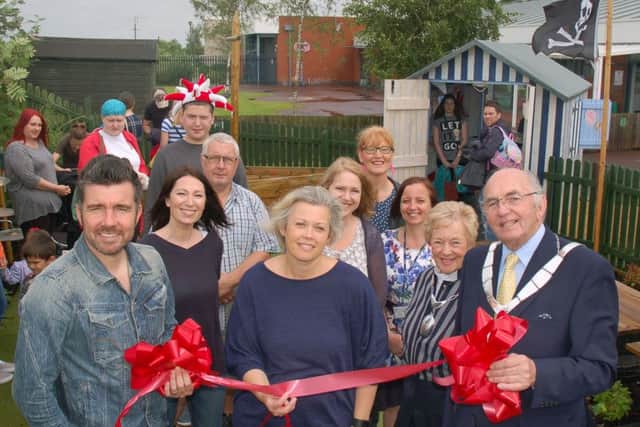 Birch Wood Special School headteacher Nina Watts (centre) is pictured with Melton Mayor David Wright and his wife (right), and Muzzy Izzet (left) cutting the ribbon for opening of the school's new sensory garden
PHOTO: Tim Williams