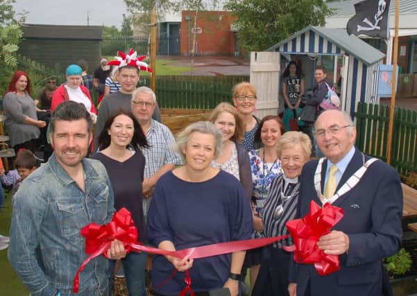 Birch Wood Special School headteacher Nina Watts (centre) is pictured with Melton Mayor David Wright and his wife (right), and Muzzy Izzet (left) cutting the ribbon for opening of the school's new sensory garden
PHOTO: Tim Williams