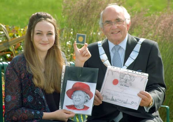 Emily Sewell receives her certificate, voucher and commemorative coin from Mayor David Wright 
PHOTO: Tim Williams