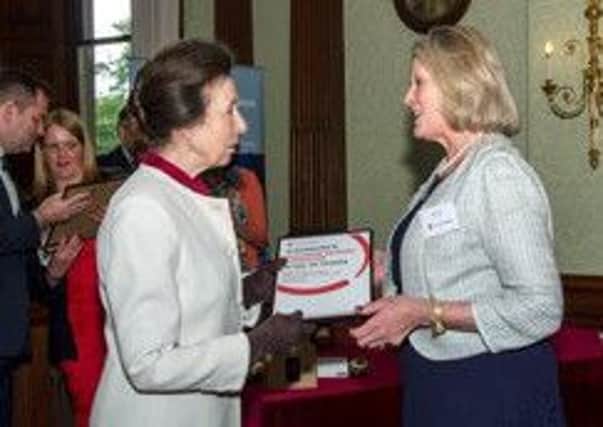 Nicki receives her outstanding contribution award from Princess Anne, president of Save the Children EMN-160907-143206001