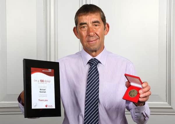 Melton man Michael Newham (67) received his award for reaching his 100th blood donation milestone EMN-160714-195940001