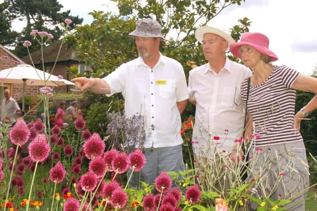 Garden owner Richard Lawrence shows guests Roger and Irene Peutrill around PHOTO: Tim Williams