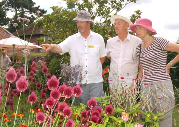 Garden owner Richard Lawrence shows guests Roger and Irene Peutrill around PHOTO: Tim Williams