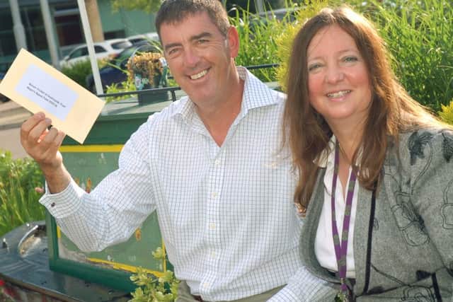 Darren Bicknell of the Belvoir Cricket and Countryside Trust receives a cheuqe from former Melton Mayor Councillor Jeanne Douglas
PHOTO: Tim Williams
