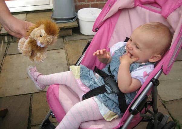 Lucie-Mai Baker, who died from encephalitis at the age of 17-months, pictured here with her pal Lion EMN-160720-144130001