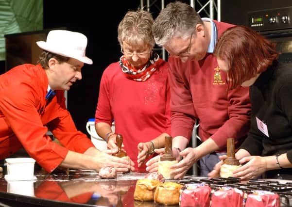 This photo, taken at last year's Melton Mowbray Food Festival, shows baker and Dickinson and Morris managing director Stephen Hallam giving tips to visitors on how to make a hand raised pork pie EMN-160723-163813001