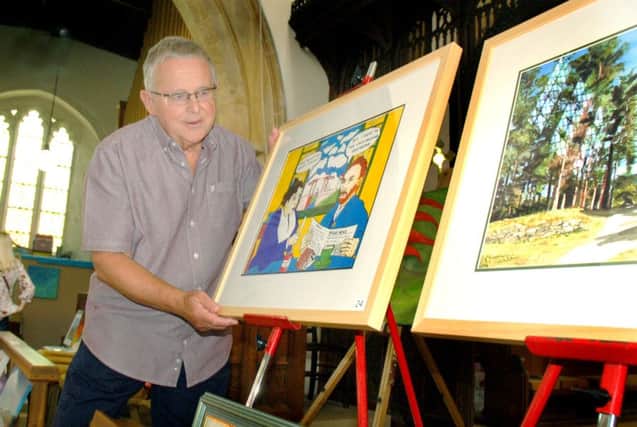 Geoff Collier with examples of his oils and ink artwork 
PHOTO: Tim Williams