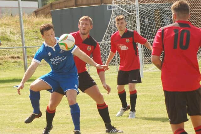 Potton United's Daniel Webb, who scored twice, on the ball, marshalled by Ben Lapworth EMN-160908-095650002