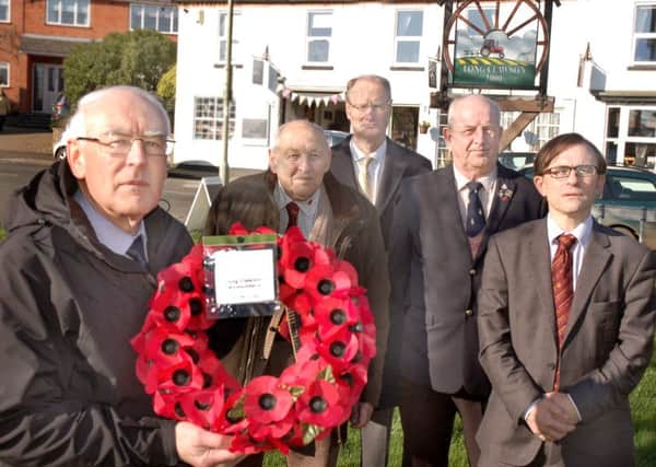 Holding the poppy wreath at the site where the memorial will go, on the village green at The Sands, is group leader pastor Eric Moxham with representatives from the three churches and the Royal British Legion. Pictured at the back, from left, are John Doubleday, Glen Arnold, Peter Hackett and Peter Sutton. EMN-161208-145749001