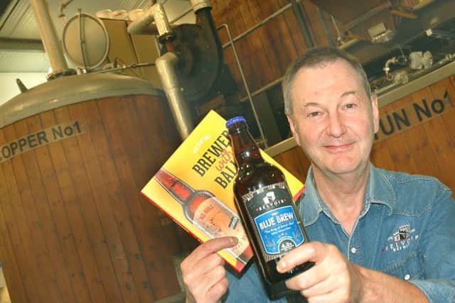 Belvoir Brewery director/head brewer Colin Brown with a bottle of their Blue Brew and copy of the new book EMN-160816-133317001