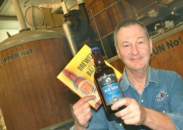 Belvoir Brewery director/head brewer Colin Brown with a bottle of their Blue Brew and copy of the new book EMN-160816-133317001