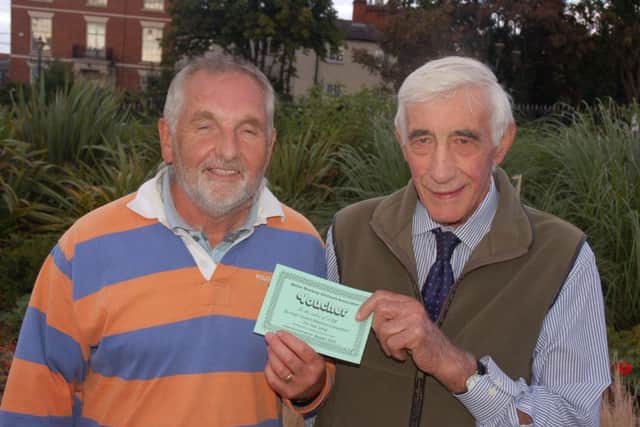 John Abbott is presented with vouchers for Redwood Avenue by judge councillor Gerald Botterill PHOTO: Tim Williams