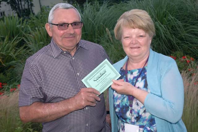 Gerald Jones accepts vouchers for Lake Terrace from judge councillor Margaret Glancy PHOTO: Tim Williams