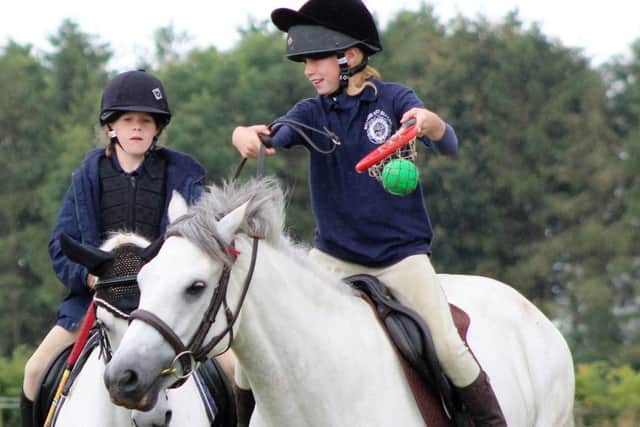 Emma Joy and Zara Pollock trying polocrosse
PHOTO: Supplied