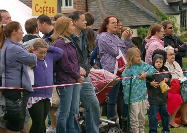 Crowds watch the action on the village green at Old Dalby Day 

PHOTO: Tim Williams