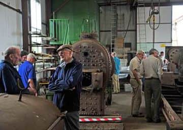 A view of the workshop with two Eastwell Ironstone former employees catching up on bygone days EMN-160817-184521001