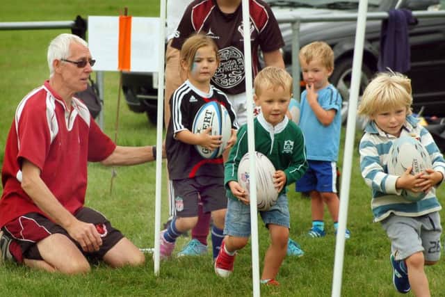 Minis coach Phil Wood puts some under 5s through their paces EMN-160823-185340002