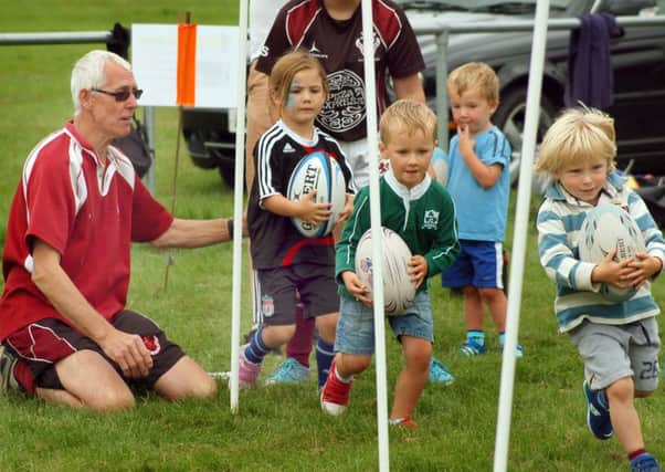 Minis coach Phil Wood puts some under 5s through their paces EMN-160823-185340002