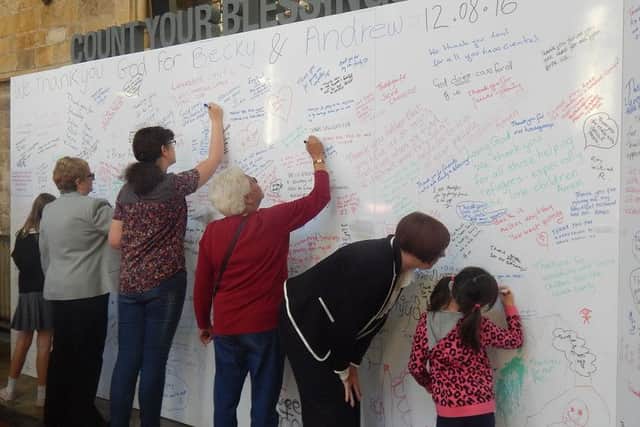 Parishioners at St Mary's Church write on the boards PHOTO: Supplied