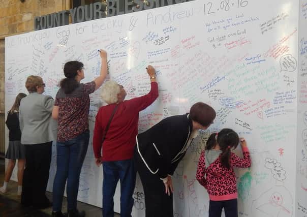 Parishioners at St Mary's Church write on the boards PHOTO: Supplied