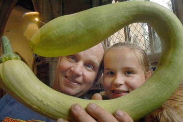 Colin Ramsay and daughter Rachel examine his Trumbatini Pumpkin which won the most unusually shaped vegetable PHOTO: Tim Williams