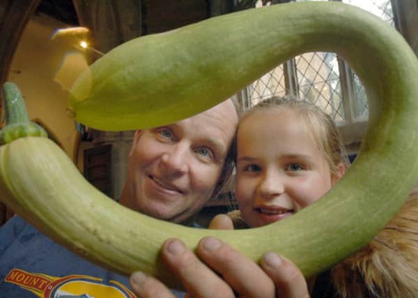 Colin Ramsay and daughter Rachel examine his Trumbatini Pumpkin which won the most unusually shaped vegetable PHOTO: Tim Williams