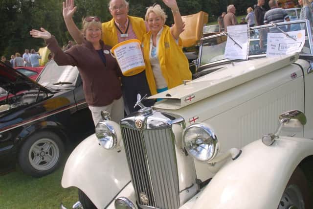 Aurura Rotary president Kate Jones, Rotary president Ian Neale and Julia Hinde with a classic 1951 MG PHOTO: Tim Williams
