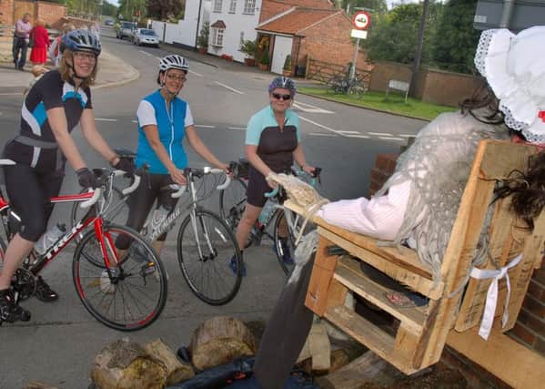 Cyclists Ali Oldfield, Sandy Roy and Maria Dobney stop to admire one of the High Street creations 
PHOTO: Tim Williams