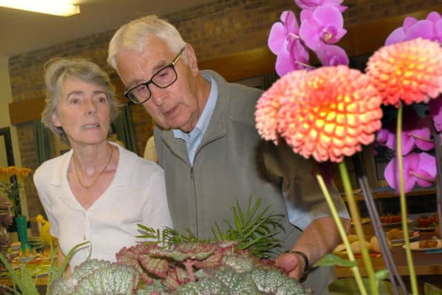 Linda White and Don Shields admire some prize winning blooms 
PHOTO: Tim Williams