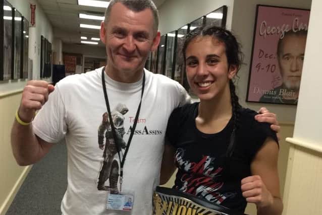 Iman Barlow with dad and coach Mark and her 12th world title belt EMN-160709-094729002