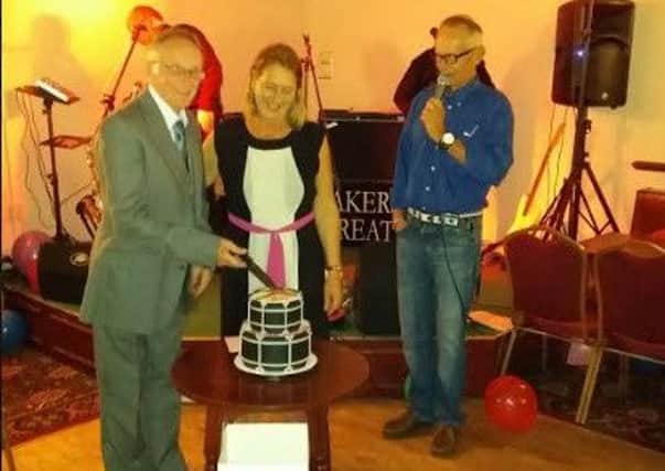 Mick Short and Karen Joyce cut the cake to mark the Melton Mowbray Tally Ho Marching Band's 80th anniversary PHOTO: Supplied