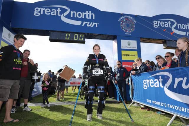 Claire Lomas crosses the finish line in her robotic suit during the Great North Run in Newcastle EMN-160914-093527001