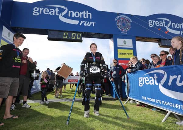Claire Lomas crosses the finish line in her robotic suit during the Great North Run in Newcastle EMN-160914-093527001