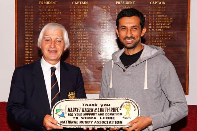 Rohit presents a plaque from the Sierra Leone National Rugby Association to Market Rasen and Louth RFC president Tony Smith EMN-160909-095610002
